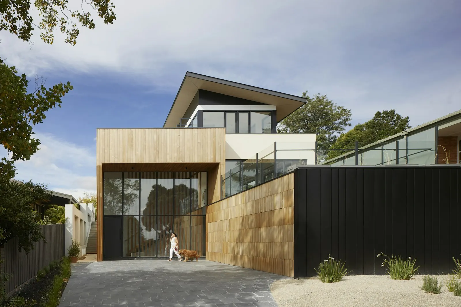 Main living pavillion with double-height ceiling and seamless terrace connection